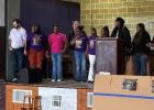 City officials and community members walk arm in arm during the Martin Luther King Jr. Day Celebration at O.J. Thomas School on Monday, Jan. 19. Participants gathered at the school before marching through the surrounding neighborhood to honor the life, le