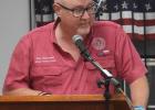 Top left: The veterans at the Cameron VFW Hall salute the flag. Left: The Yoe High band performs the salute to services. Below: Bill Whitmire speaks at the podium. Photos by Ryan Heller/Cameron Herald