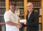 Assistant Fire Chief Phillip Dohnalik accepts a donation on behalf of the Cameron Volunteer Fire Department from Richard Dodd, who represented himself, Timothy Cappolino and Ryan Krebs, and their law firm, Cappolino, Dodd and Krebs.