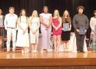 The new National Honors Society Inductees stop for a photo with the current NHS leadership team after their induction ceremony, Wednesday, April 1.