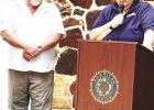 Randy McBay, American Legion Post 9 Vice Commander, listens as Past Commander Jean Schara shares the history of Flag Day.