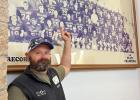 Trey Felton and a photo of the 1995 football team where it hangs in the school gym. Photo Courtesy of Trey Felton