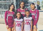 A few of the OYE high school cheerleaders came out to support the Pee Wee youth football teams this past Saturday. Pictured, left to right, are OYE cheerleaders Jimena Flores, Makaleigh May, and Aaliyah Johnson. Football players in front, left to right, a